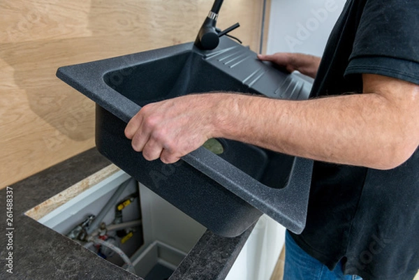 Obraz Installing a new ceramic sink in kitchen