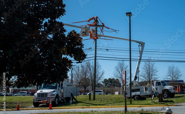 Fototapeta men in bucket on extended cherry pickers