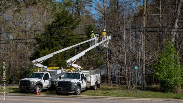 Obraz Two workers in a cherry picker bucket