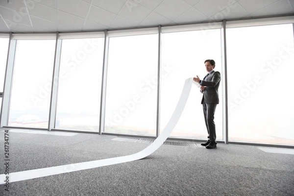 Obraz Businessman reading long paper list