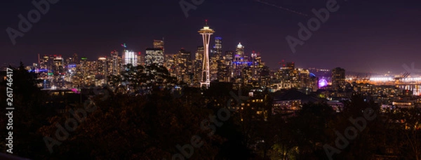 Fototapeta Panoramic night view of the Seattle skyline with the Space Needle and other iconic buildings in the background.