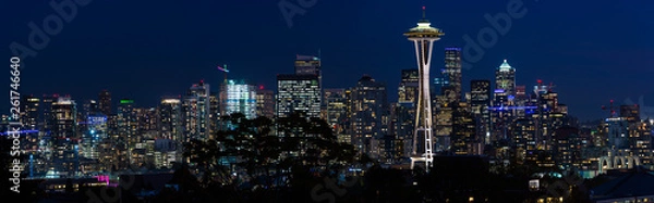 Fototapeta Panoramic night view of the Seattle skyline with the Space Needle and other iconic buildings in the background.
