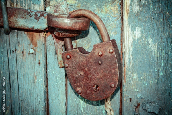 Obraz Old rusty closed lock without key. Vintage wooden door, close up concept photo