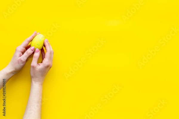 Fototapeta eggs with colorful paint for easter tradition on yellow background top view mockup