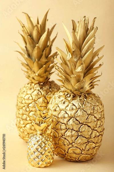 Fototapeta Golden pineapples on color background