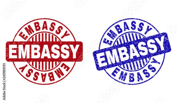 Fototapeta Grunge EMBASSY round stamp seals isolated on a white background. Round seals with grunge texture in red and blue colors. Vector rubber imprint of EMBASSY label inside circle form with stripes.