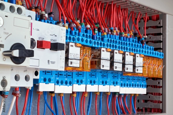 Fototapeta Motor protection circuit breakers and intermediate relays in electrical Cabinet. The wires are connected to the electrical equipment according to the scheme. Automatic control and distribution.