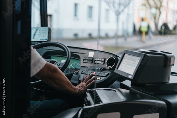Obraz Modern bus interior with drivers hand