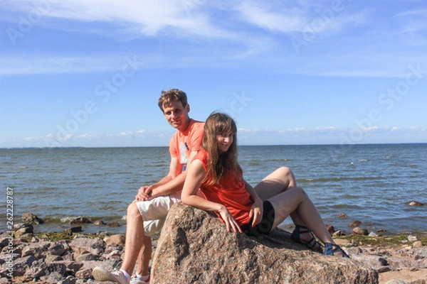 Obraz A couple of lovers sitting on boulders by the sea
