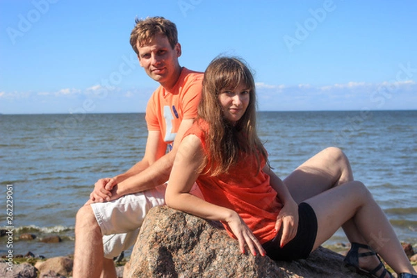 Obraz A couple of lovers sitting on boulders by the sea