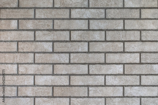 Fototapeta Closeup of modern neutral grey brick wall with dark seams. For pattern, texture and background