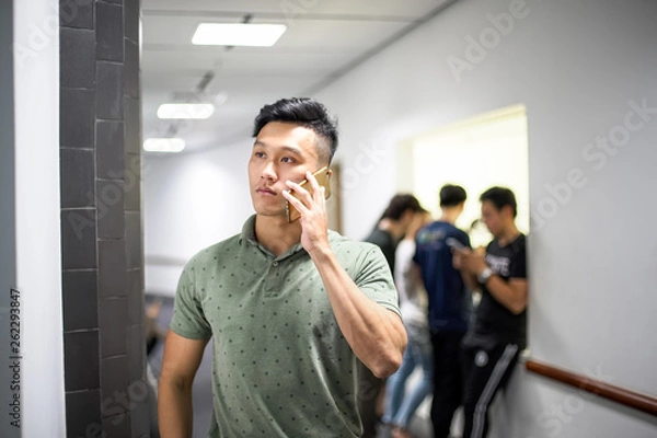 Obraz Asian handsome men talking happily on the phone | Guy smile while using smartphone