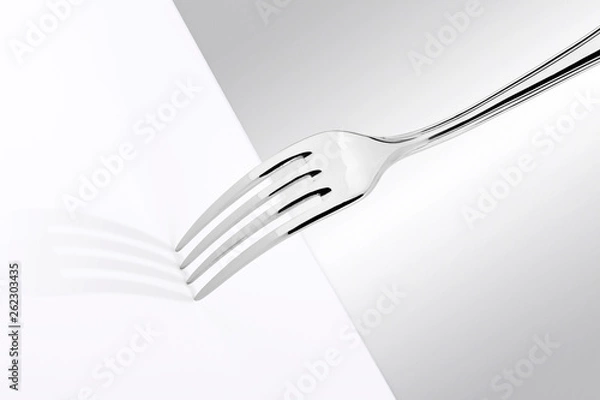 Fototapeta Fork in high key with bright setting on white table