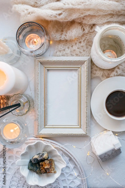 Fototapeta Beautiful candles, cup of coffee on white background, frame for your text, flat lay, top view, relax morning concept
