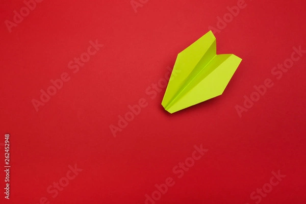 Fototapeta Flat lay of colour paper plane on red background with text space.