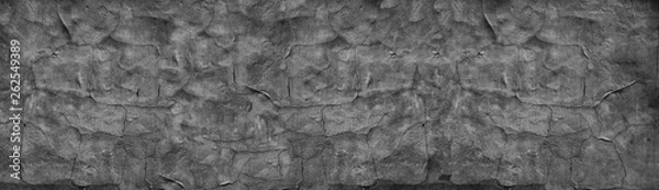 Fototapeta Black cracked concrete wall wide texture. Fine textured old weathered cement surface panorama. Dark gray panoramic retro background