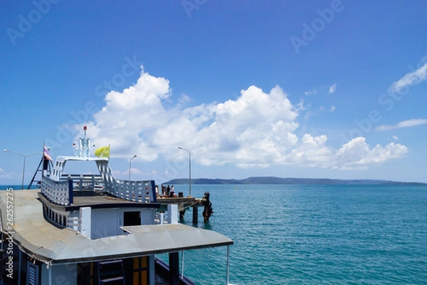 Fototapeta Passenger boat on the left side with big white cloud over the sea in background in summer, Koh Mak Island in Trat, Thailand.