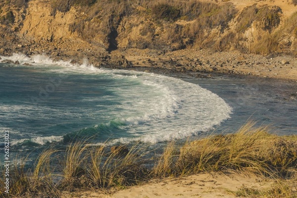Fototapeta Two waves crashing on the beach