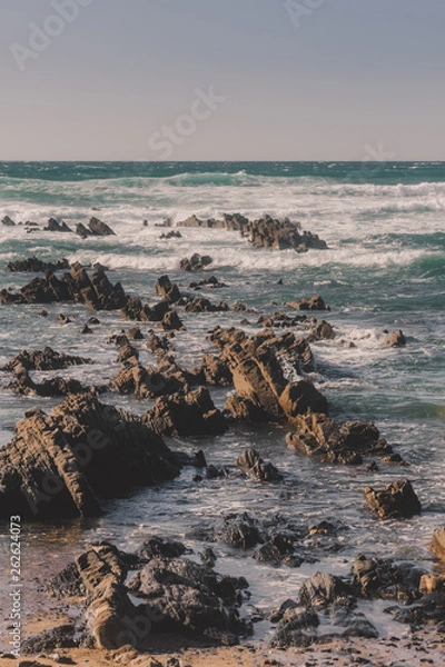 Fototapeta Waves crashing on rocks