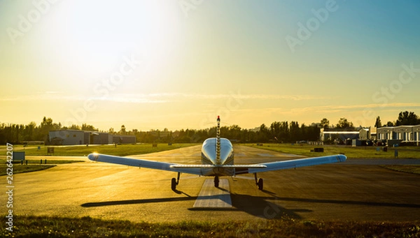 Obraz Small plane ready to take off at sunrise.