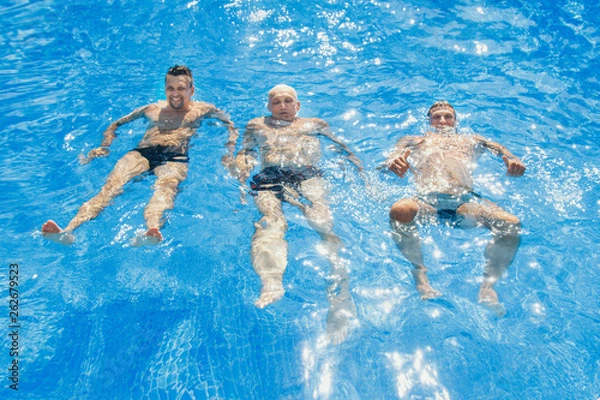 Obraz a group of men swimming in the pool
