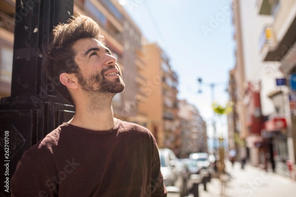 Fototapeta young man looking up