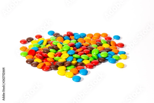 Fototapeta Colorful chocolate M&Ms in and out of focus on white background