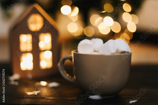 Fototapeta Christmas coffee cup with marshmallows. Still life on dark background. New Year's lights and decorations