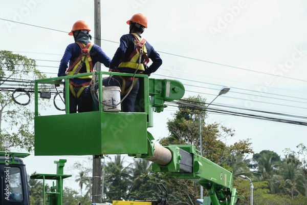 Obraz Electrical staff working on a cable car