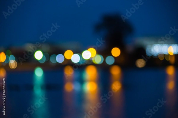 Fototapeta Beautiful blurred city lights with bokeh effect reflected on water