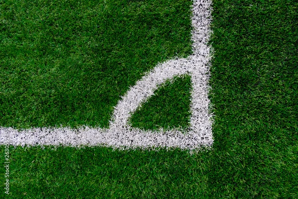 Fototapeta Artificial turf soccer field with corner marker line.