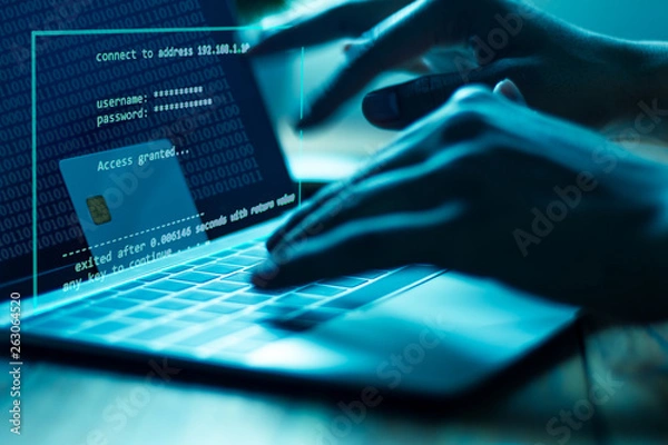 Fototapeta The concept of credit card theft. Hackers with credit cards on laptops use these data for unauthorized shopping. Unauthorized payments from credit card owners. In the hacker's secret office