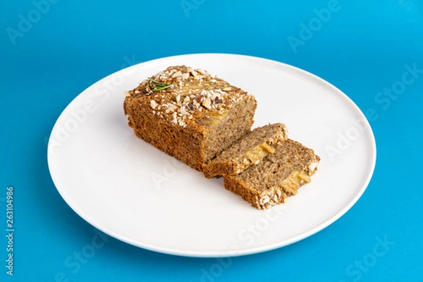 Fototapeta Almond bread loaf with Almond diced and Banana sliced set on Blue Background.