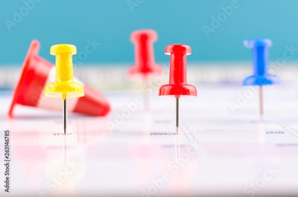 Obraz close up of colorful pin on calendar for business appointment or planning concept