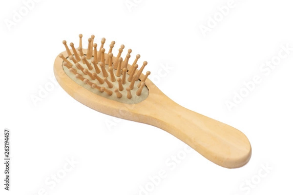 Fototapeta Wooden massage comb on a white background - isolate