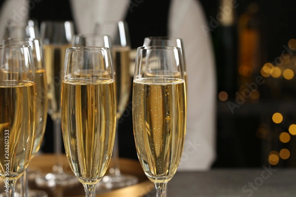 Fototapeta Glasses of champagne and waiter in restaurant, closeup. Space for text