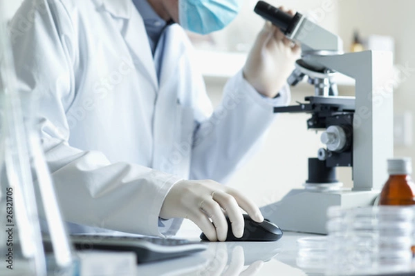 Obraz Scientist with  microscope and computer