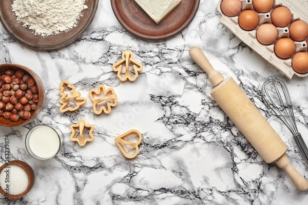 Fototapeta Close-up shot. Top view of a baking ingredients and kitchenware on the marble table background.