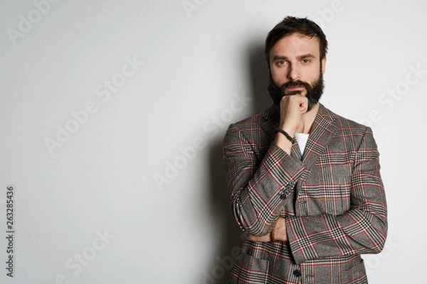 Fototapeta Handsome cheerful man standing over white background and looking camera. Mockup Copy Paste Advertisement