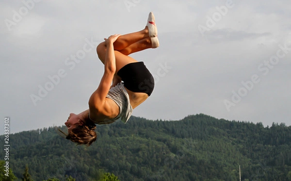 Fototapeta gymnast doing somersault