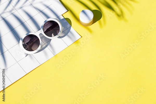 Fototapeta Summer yellow cosmetics flat lay with sunglasses . Top view beauty composition. Copy space