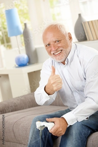 Obraz Starszy mężczyzna daje kciuk z grą komputerową