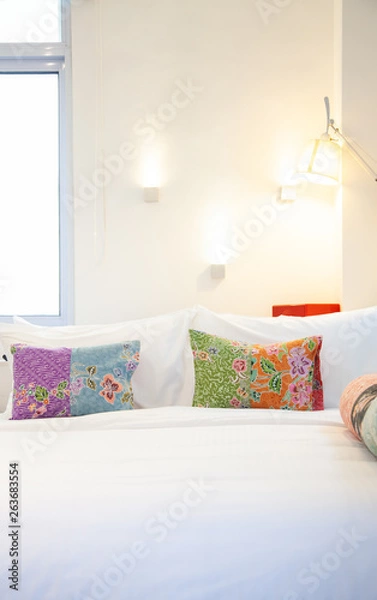 Fototapeta bed with colorful pillows - cozy bedroom