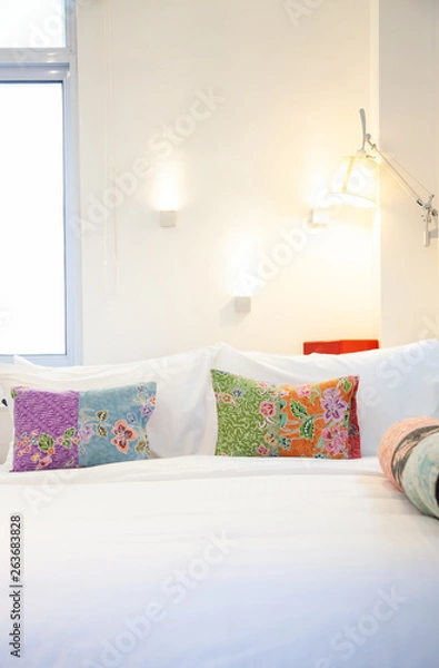 Obraz bed with colorful pillows - cozy bedroom
