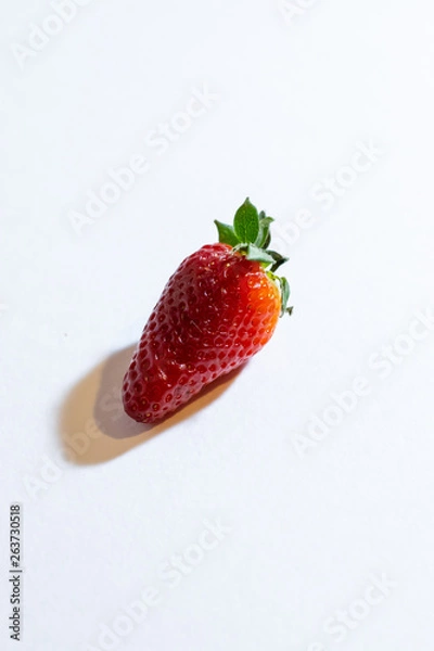 Fototapeta Fresh strawberry berries on a white background. Vertical orientation