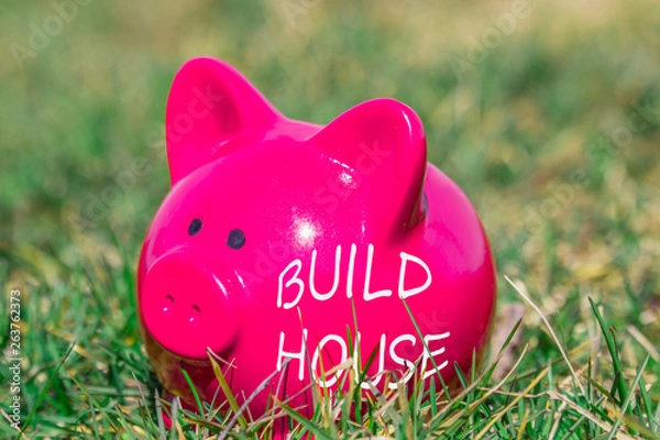 Obraz Pink piggy bank on the grass