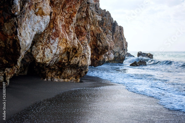 Fototapeta Sandy beach and soft blue ocean wave with white foam.