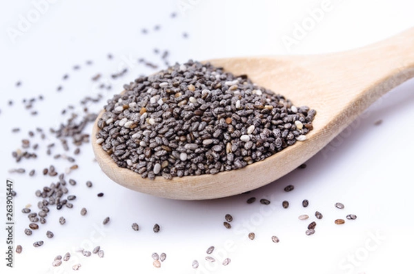 Fototapeta chia seeds in a wooden scoop isolated on white