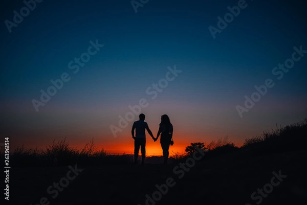 Obraz Young couple enjoying sunset in the mountains