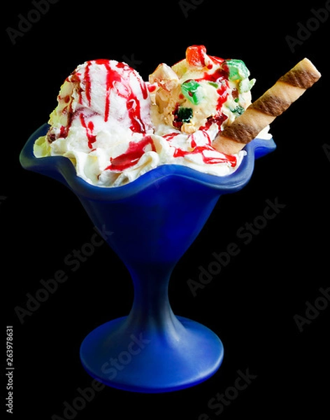Obraz Ice cream in a blue glass isolated on a black background